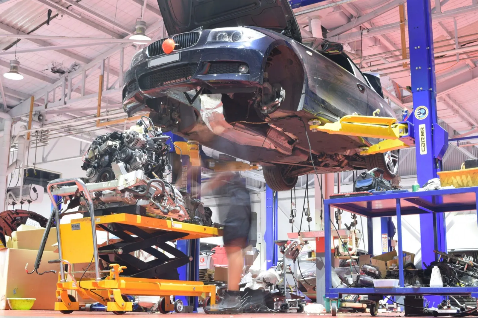 Technician working on a car raised on a hoist at our Mascot workshop