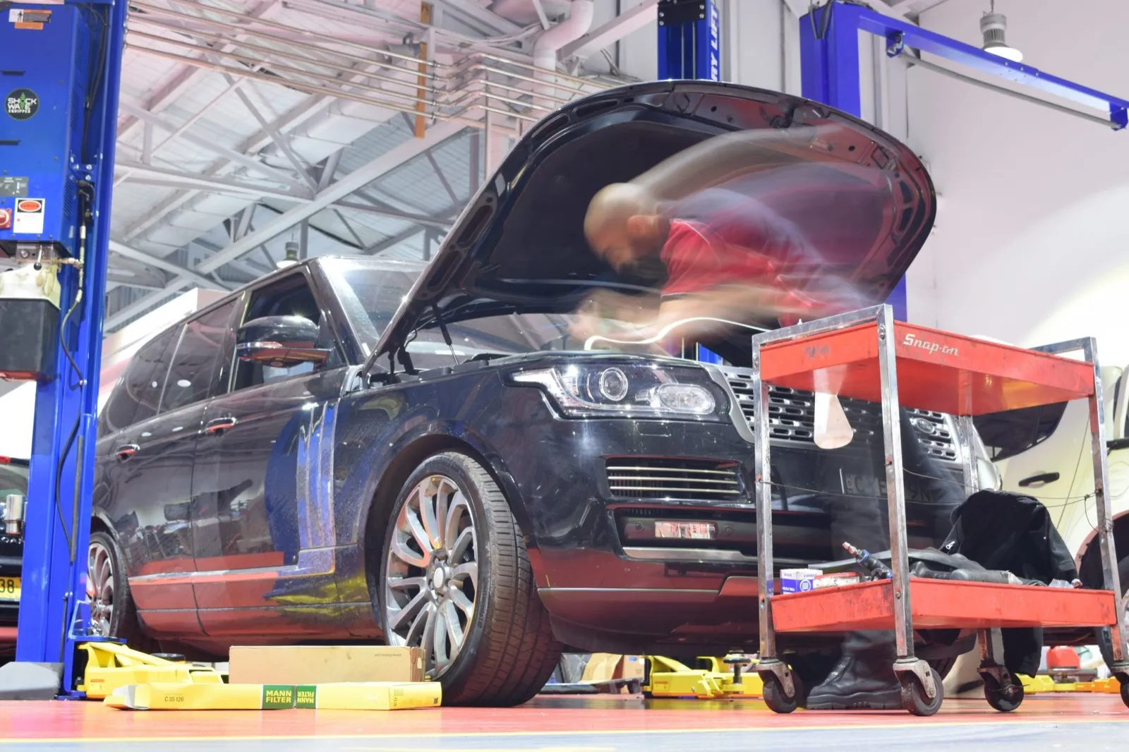 A vehicle being serviced on the hoist at Hitech Auto Services
